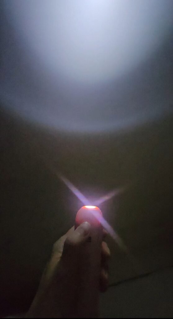 JISULIFE 3-in-1 handheld fan with built-in flashlight turned on