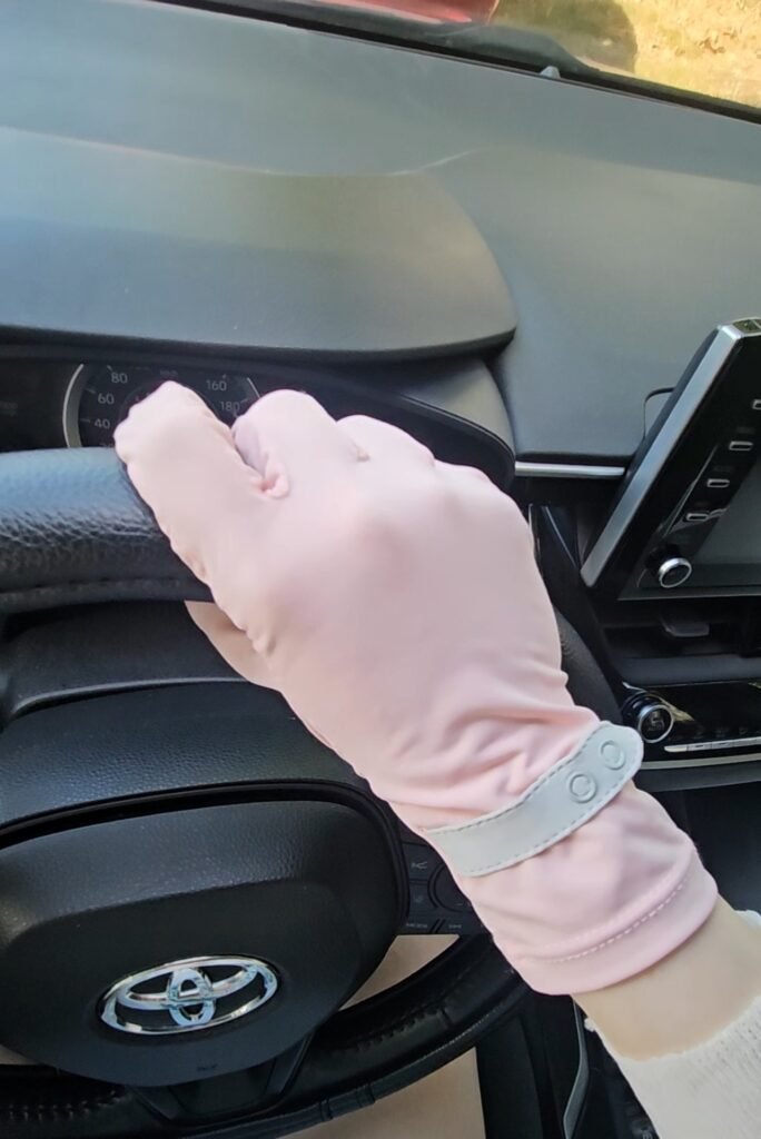 Pink UV protection gloves worn while driving