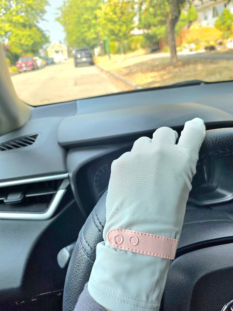UV protection gloves for driving shown on the steering wheel