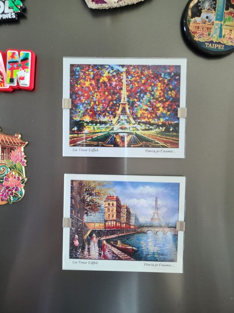 Two Eiffel Tower souvenir magnets from Paris on my refrigerator