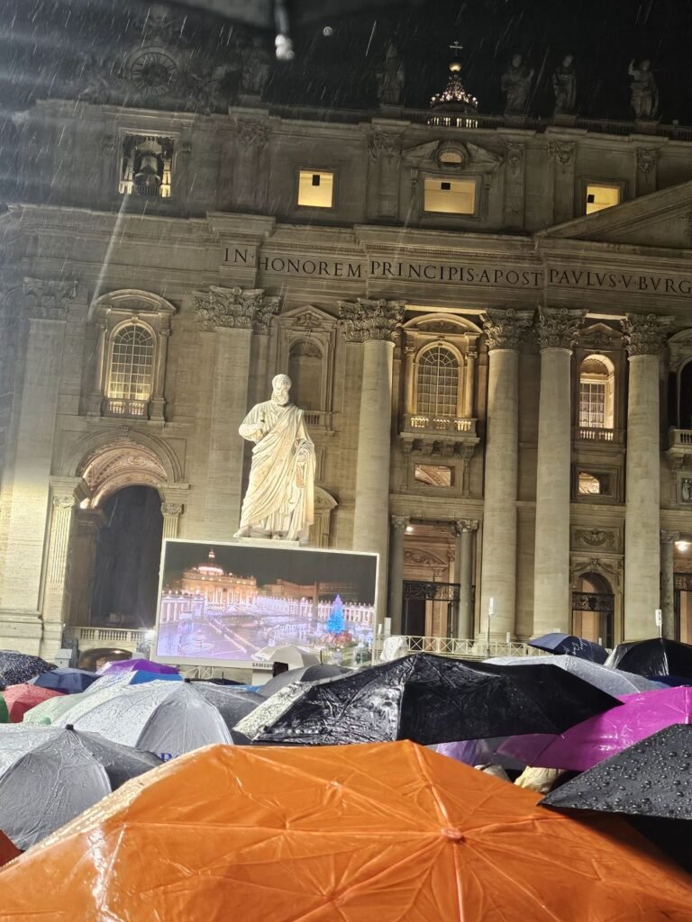 Crowd with umbrellas in St. Peter's Square on a rainy Christmas Eve