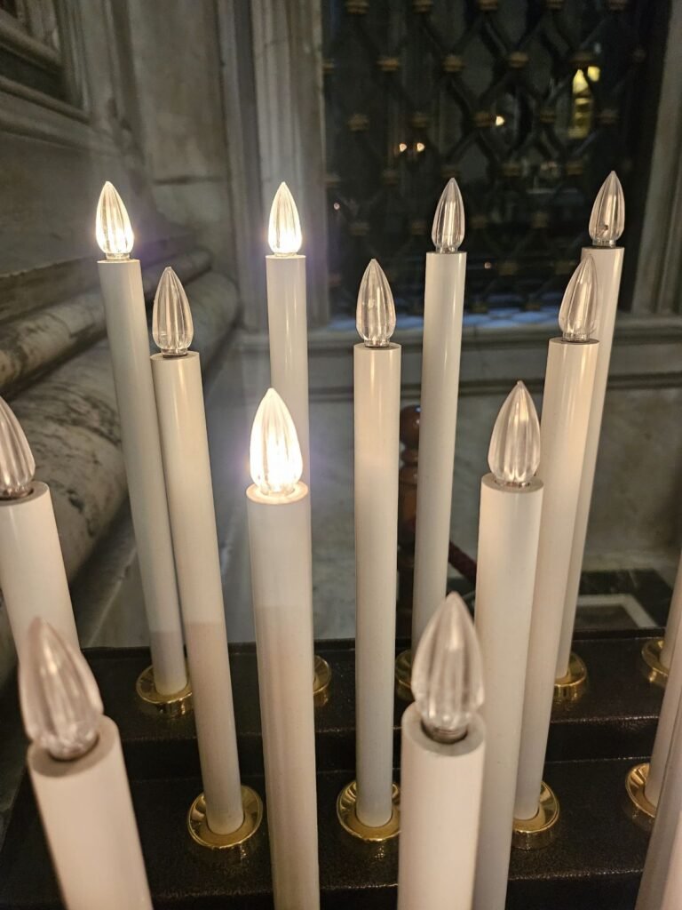 Candle lit for prayer inside St. Peter's Basilica