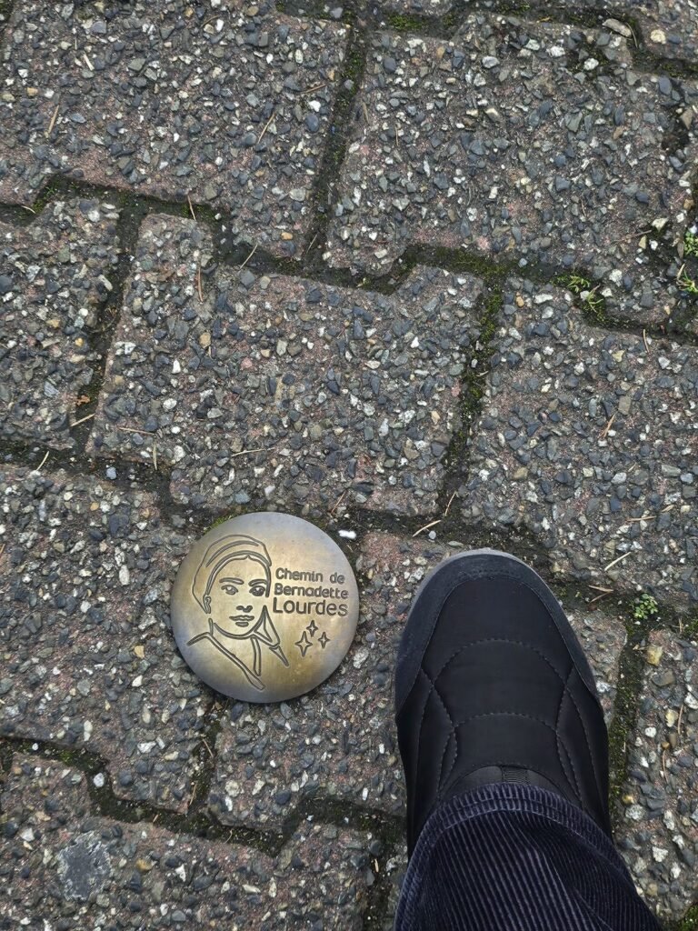 Chemin de Bernadette route marker in Lourdes