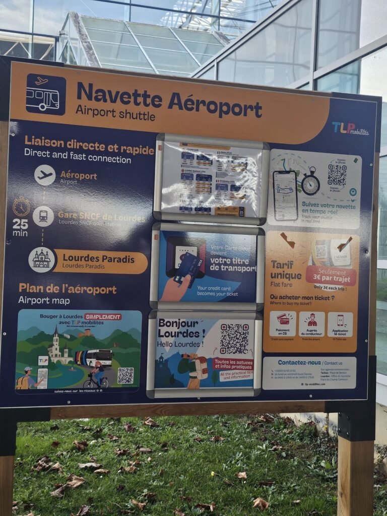 Lourdes airport shuttle bus sign outside the terminal